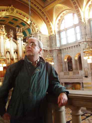 Portrait of the artist admiring some art.